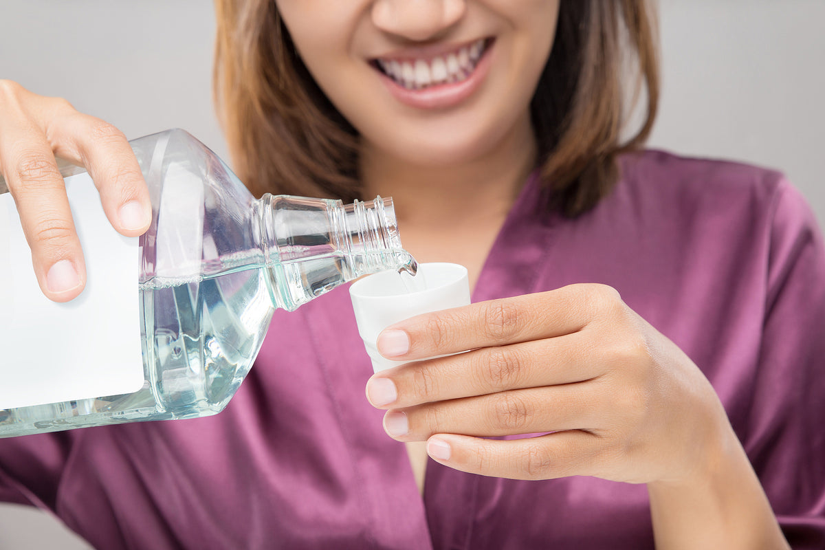 Corsodyl mouthwash daily - Woman Using Mouthwash