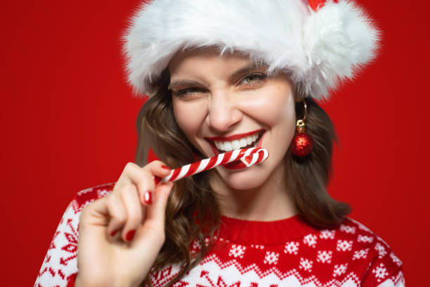 Single tuft toothbrush - woman biting christmas candy cane