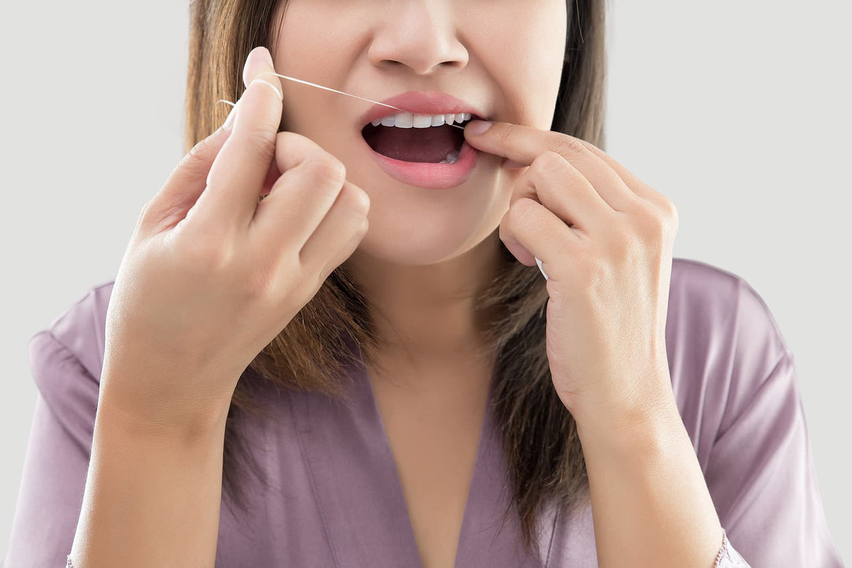 Toothbrush heads - Woman Flossing Teeth With Dental Floss