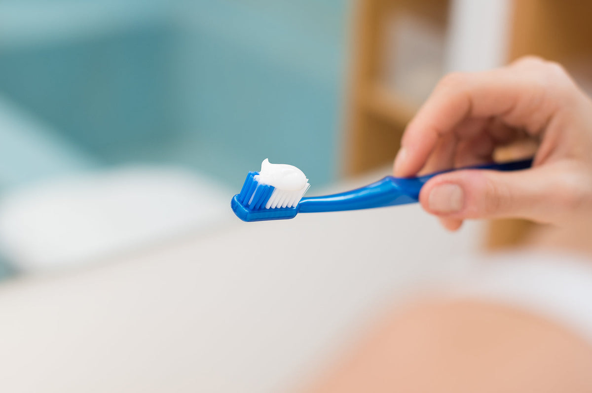 dental equipment - hand holding toothbrush