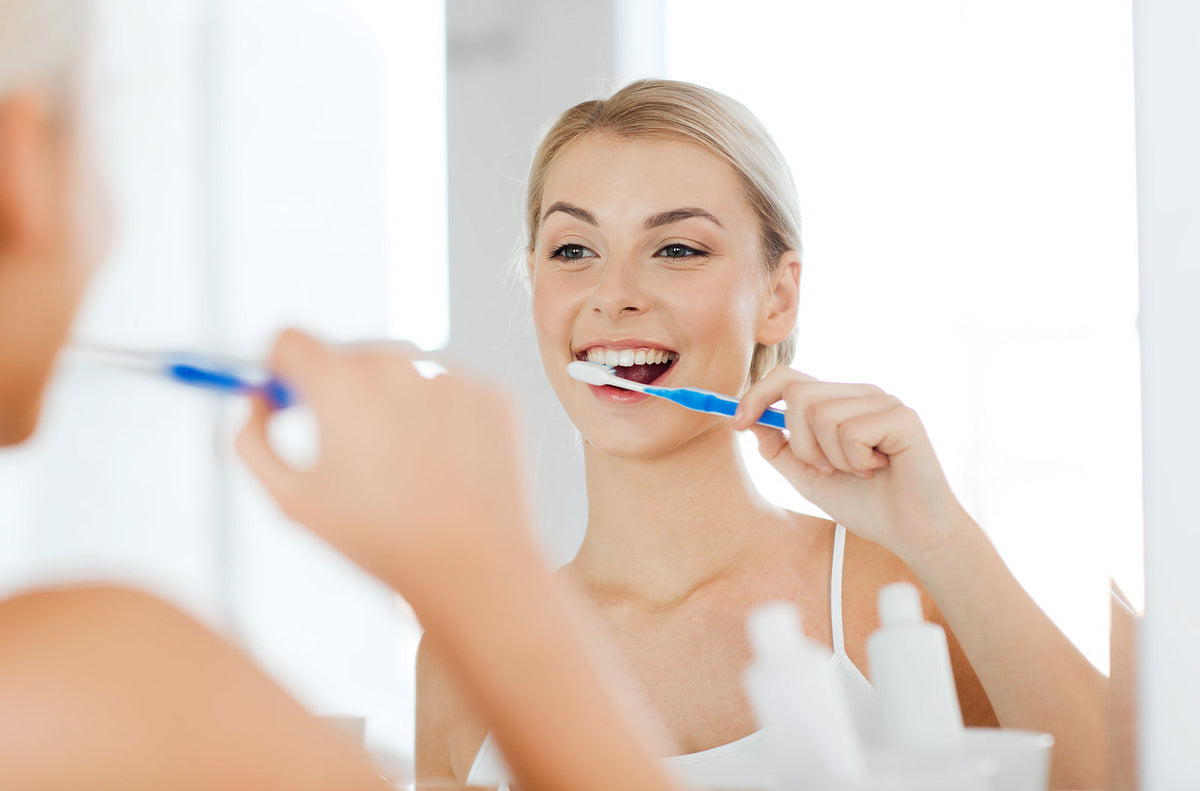 dental equipment for sale - woman with toothbrush cleaning teeth